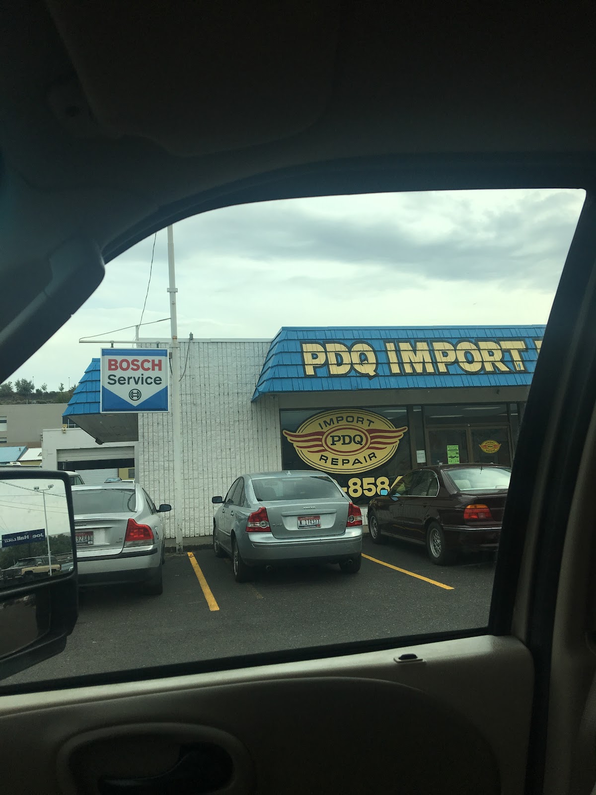 The PDQ Import Repair storefront sign and Bosch Service sign in Lewiston